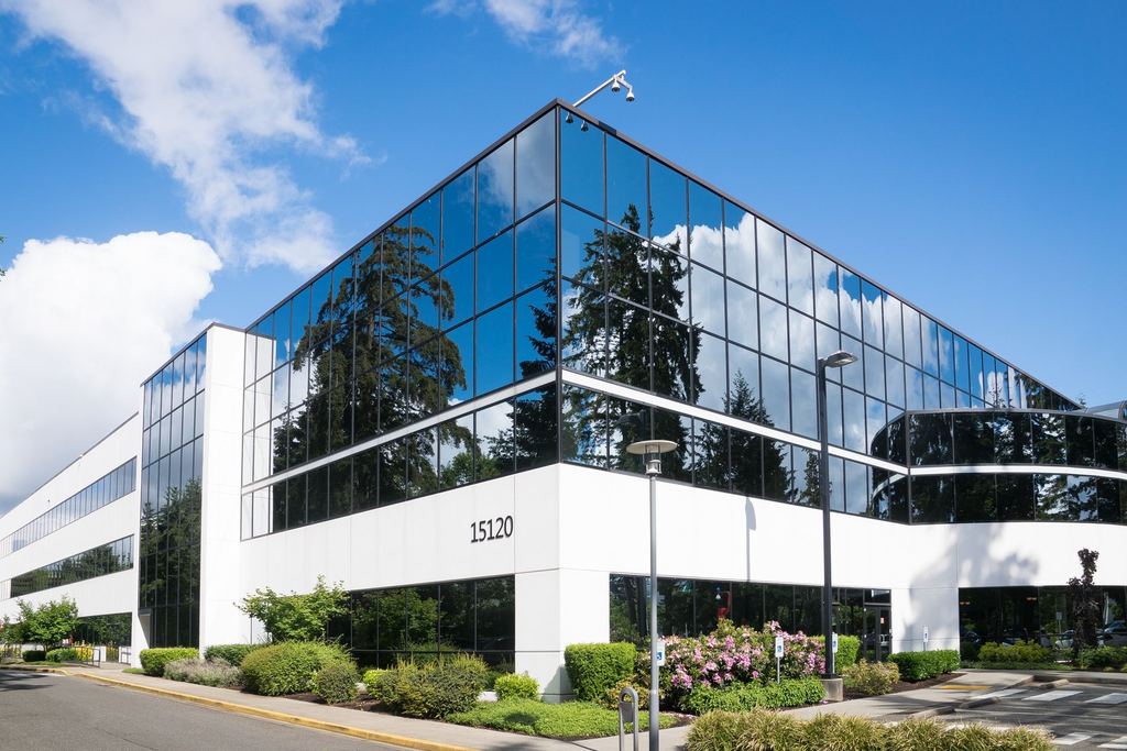 Glazed commercial office building seen from the street on a clear day
