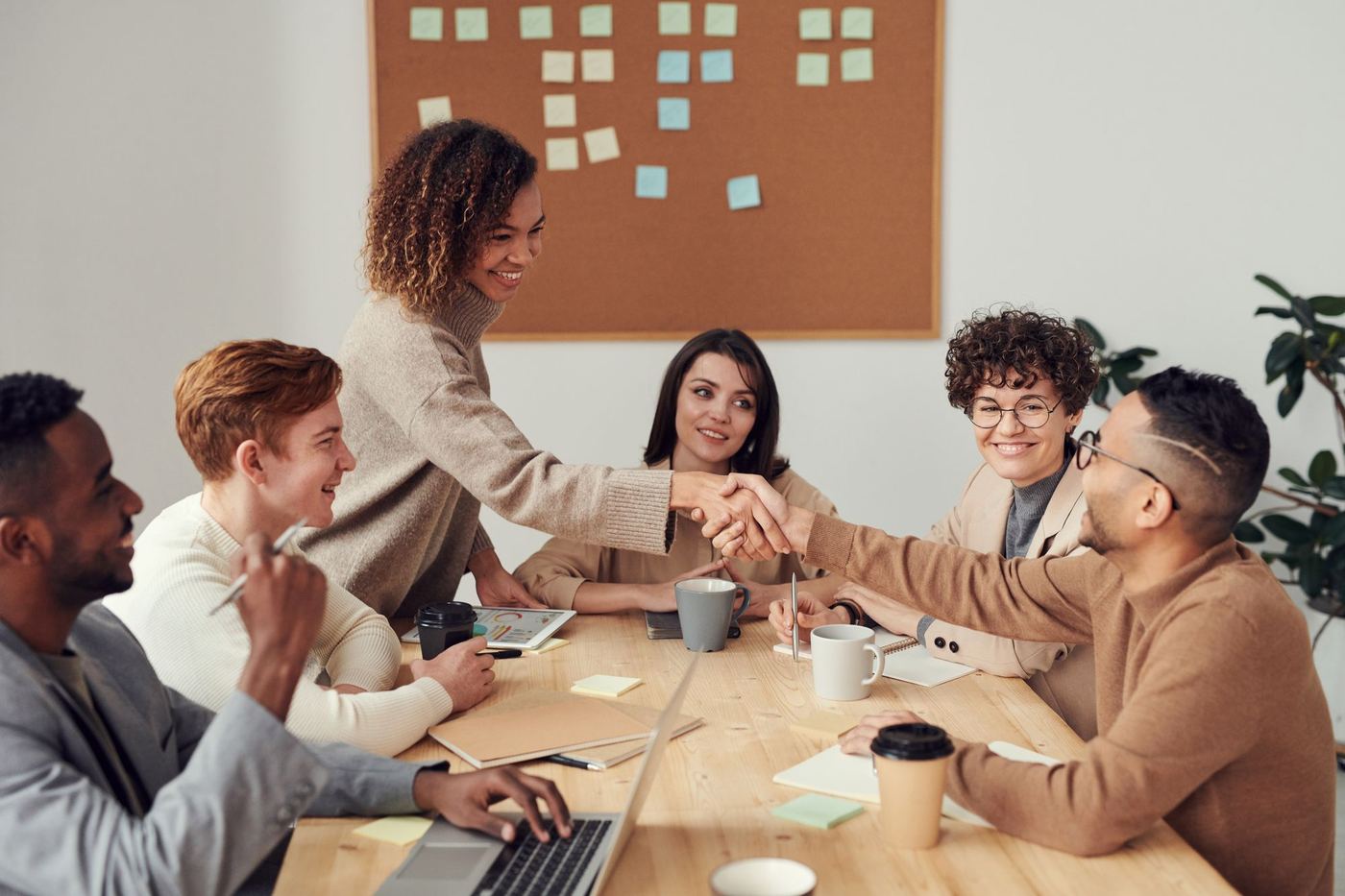 Group of professionals in conversation around a meeting table